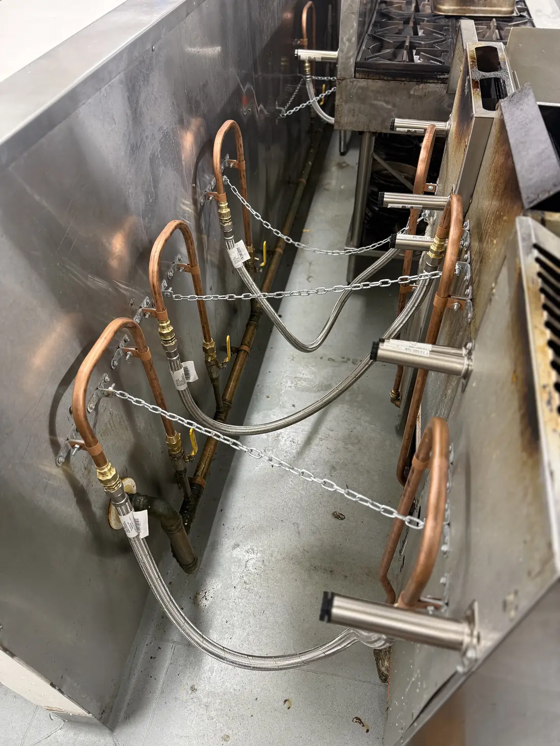 Commercial gas manifold and pipework installed as part of a kitchen fit-out.