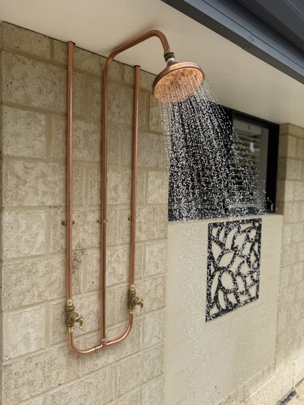 A custom outdoor copper shower installed to the client's own design.