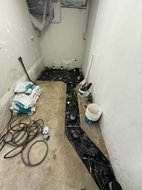 Shower base waterproofing membrane and floor preparation during a bathroom renovation