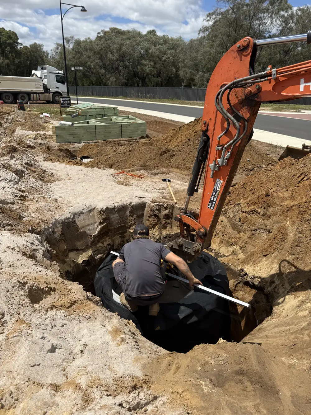 Soakwell installation and trenching to manage stormwater drainage on a Southwest property.